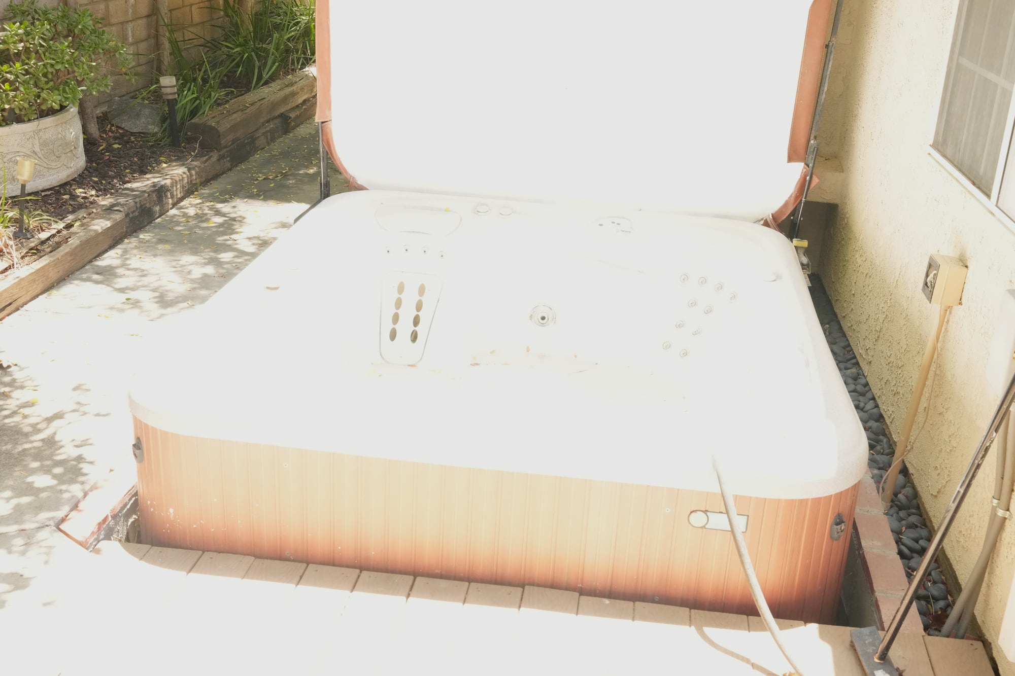 Outdoor hot tub beside the home